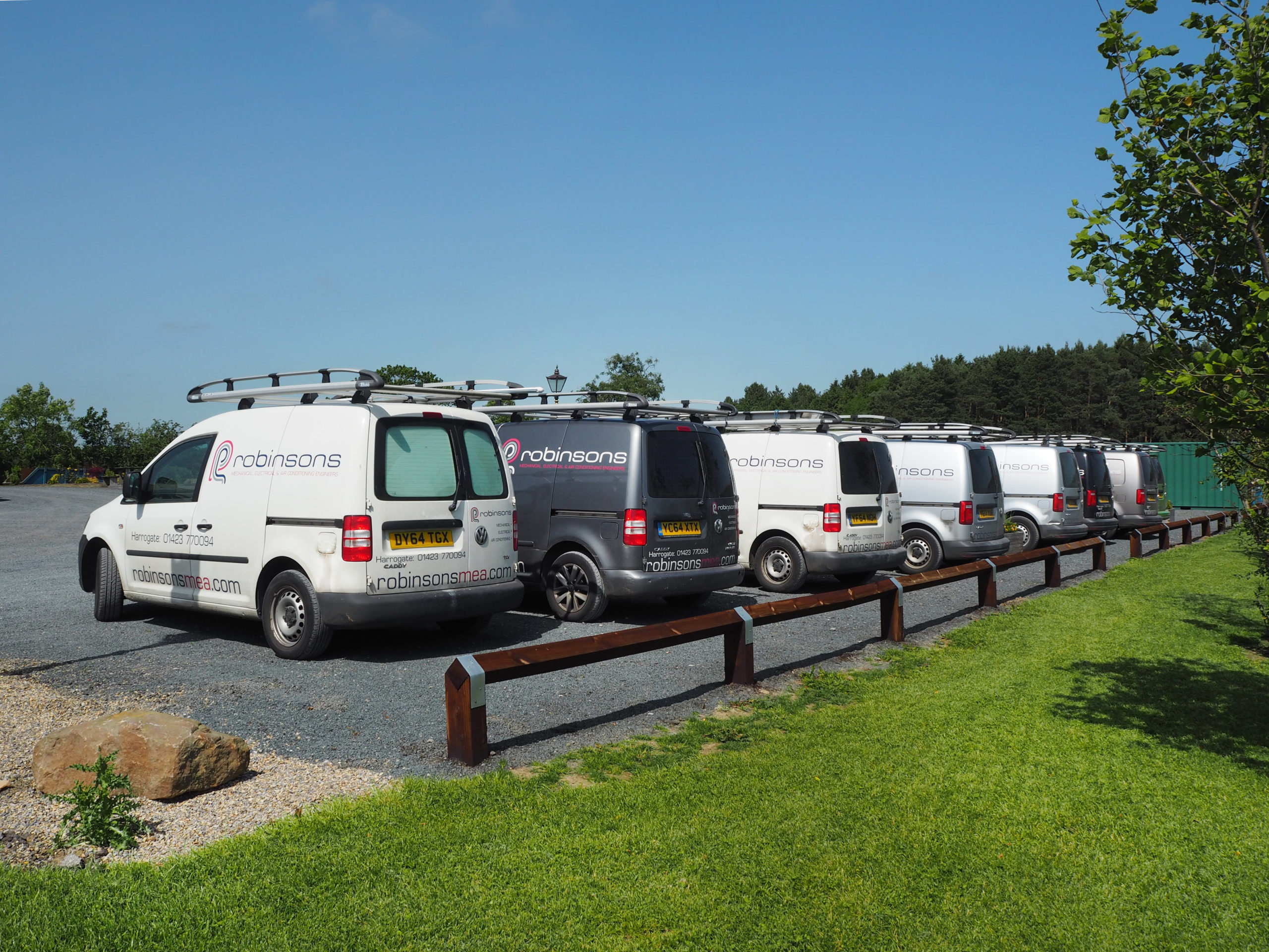 Robinsons-branded service vans parked in a row, viewed from the rear